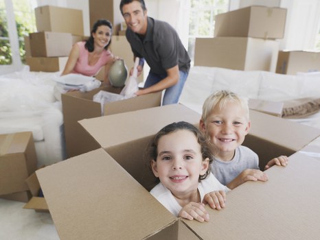 Removal team carrying items through a London property