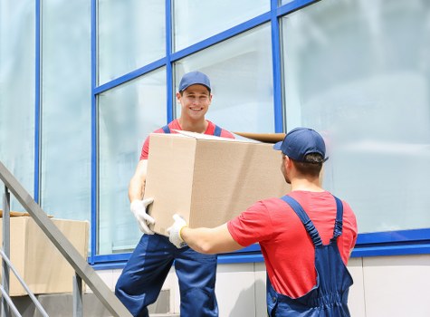 London removal team loading household furniture on a city street