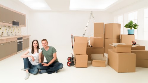Professional movers handling furniture in a London residential area