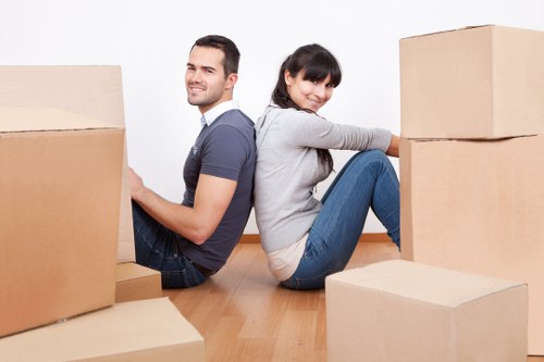 Packed boxes and furniture being loaded into a removals van in London